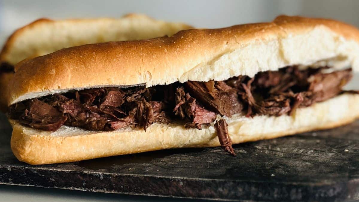 Instant Pot French dip sandwiches with tender roast beef and melted cheese, served with au jus.
