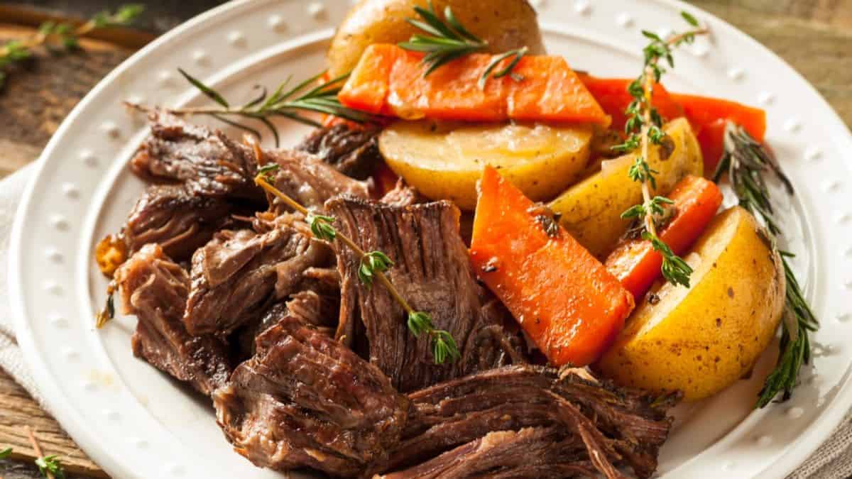 Tender pot roast cooked in an Instant Pot, served with carrots and potatoes in a rich gravy.