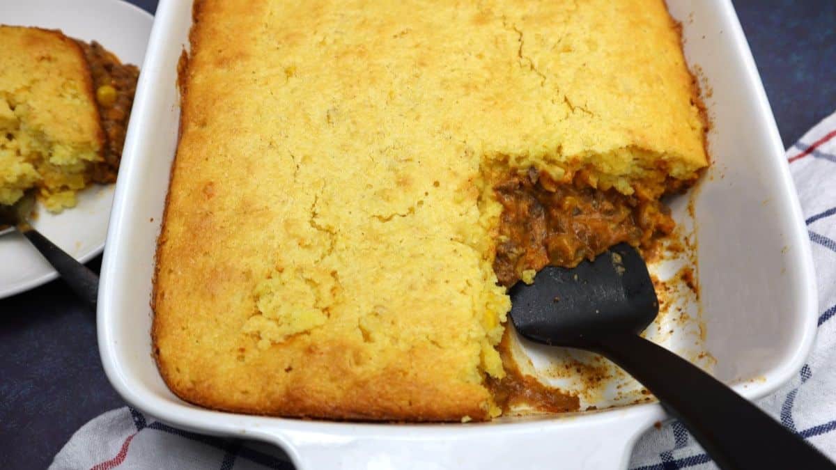 Jiffy tamale pie casserole with cornmeal crust and seasoned beef filling.