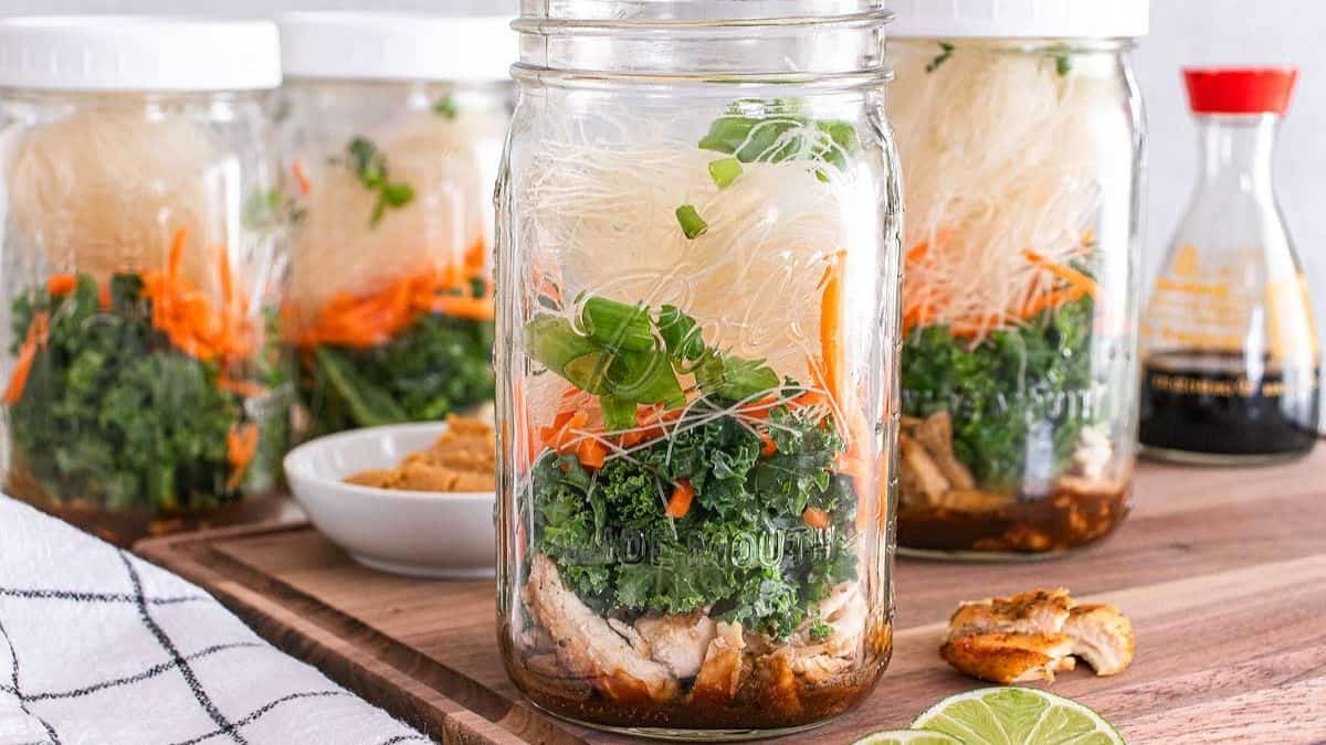 Mason jar layered with noodles and vegetables for miso chicken soup mix.