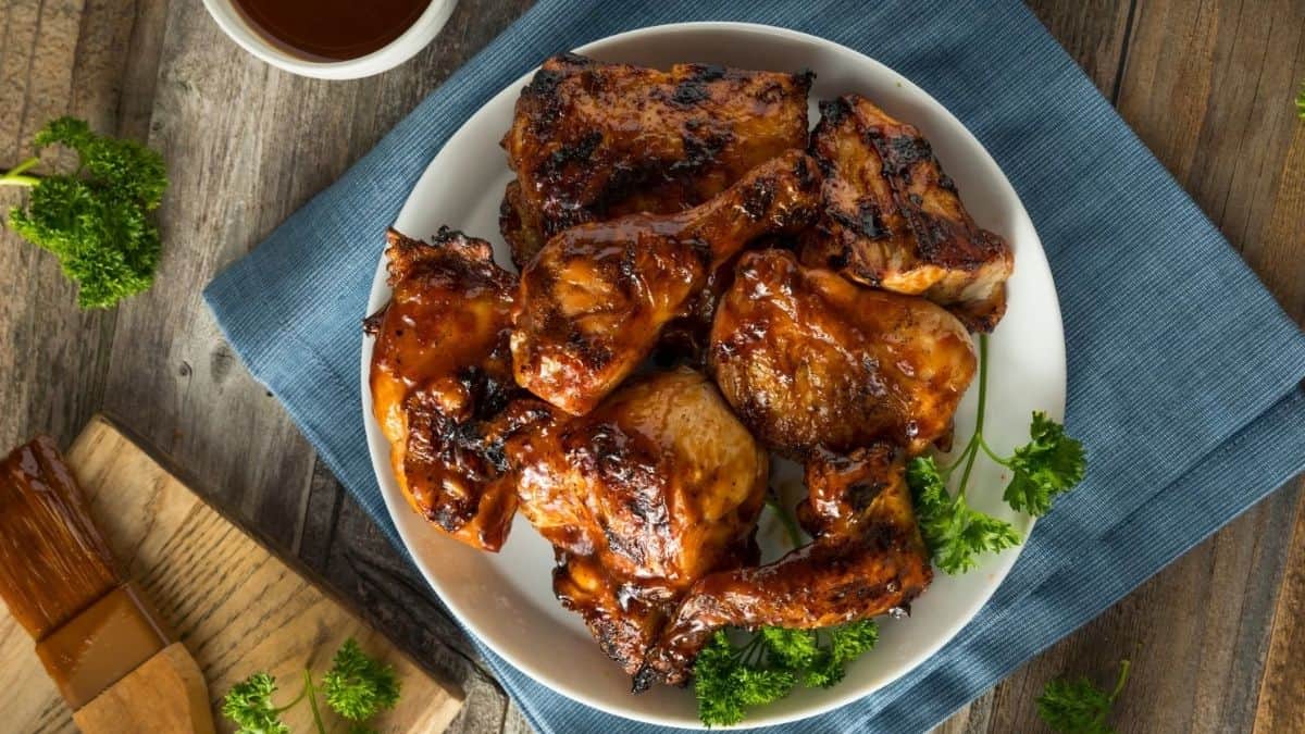 Top shot of a serving plate filled with BBQ Chicken. 
