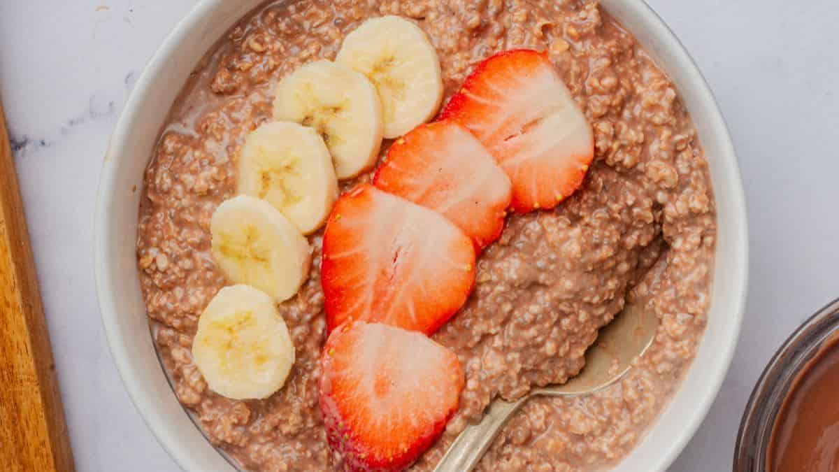 Nutella overnight oats with chocolate hazelnut swirls and oats in a glass jar.