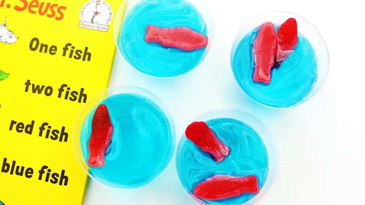 Top shot of 4 clear cups filled with blue J-ello with fish shaped candies.