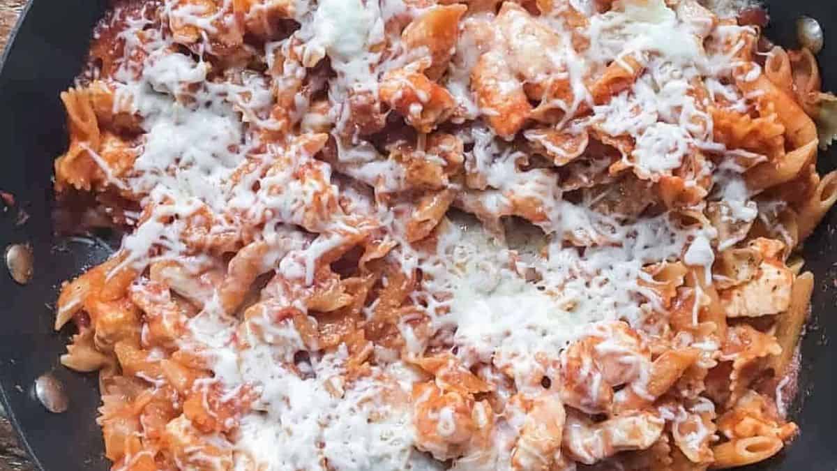 Close-up shot of Chicken Parmesan Pasta in a skillet. 