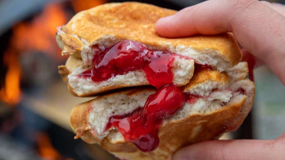 Close up shot of a Cherry Hand Pie halved and held.