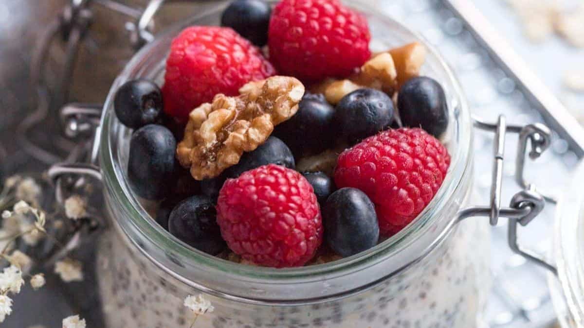 Healthy protein overnight oats with oats, seeds and berries in a jar.