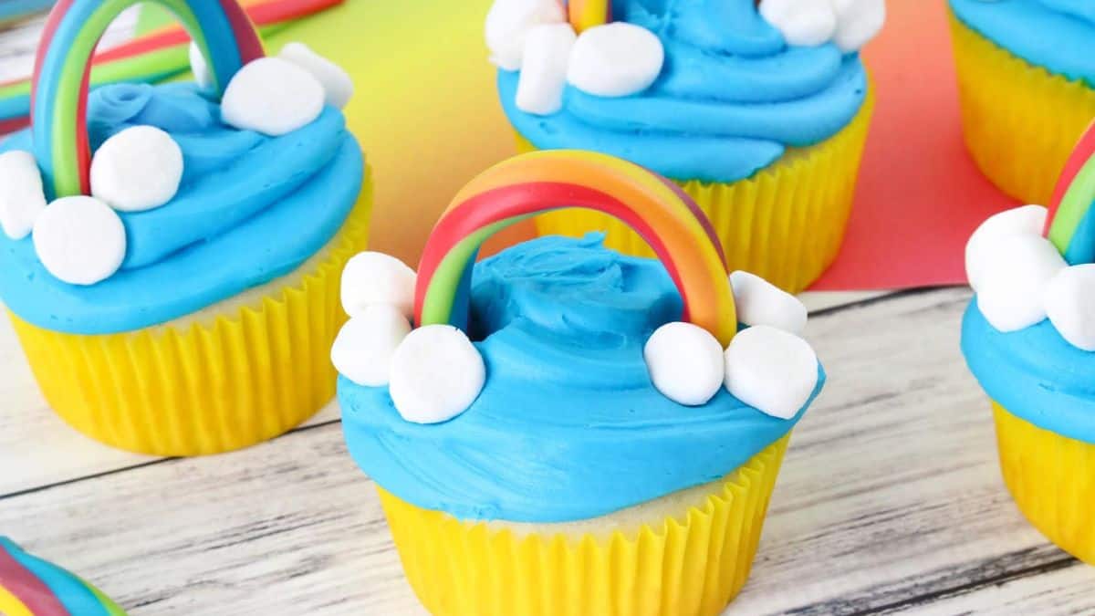 A couple of pieces of rainbow themed cupcakes.