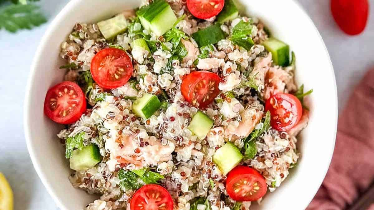 Salmon quinoa salad with cooked quinoa, grilled salmon and fresh vegetables.