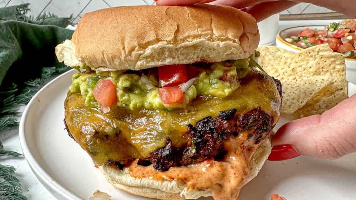 Southwest Burger with Chipotle Mayo held by a hand.