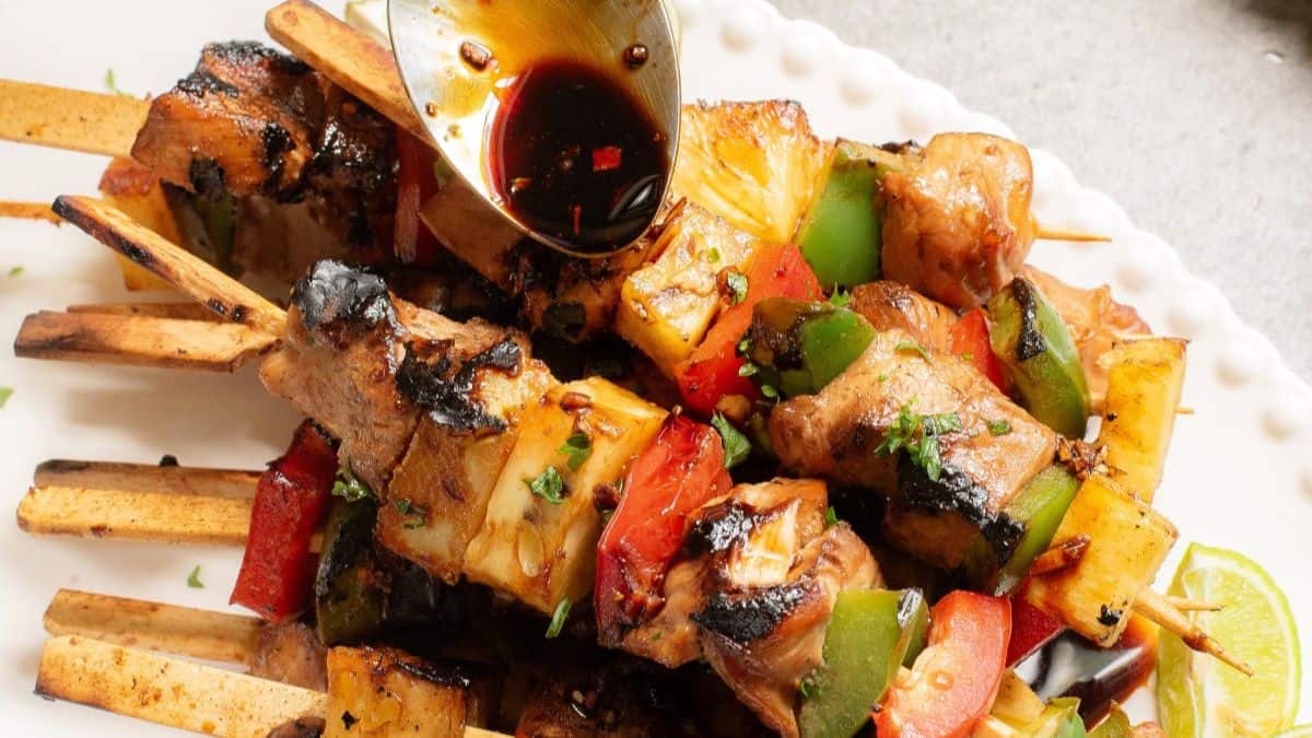 Teriyaki chicken skewers with glossy teriyaki sauce and sesame seeds.