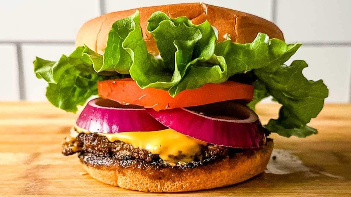 Turkey Burger with cheese, onion slices and lettuce. 