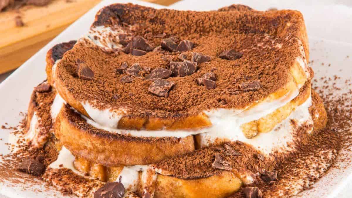 A three-tier Tiramisu French Toast set on a plate.