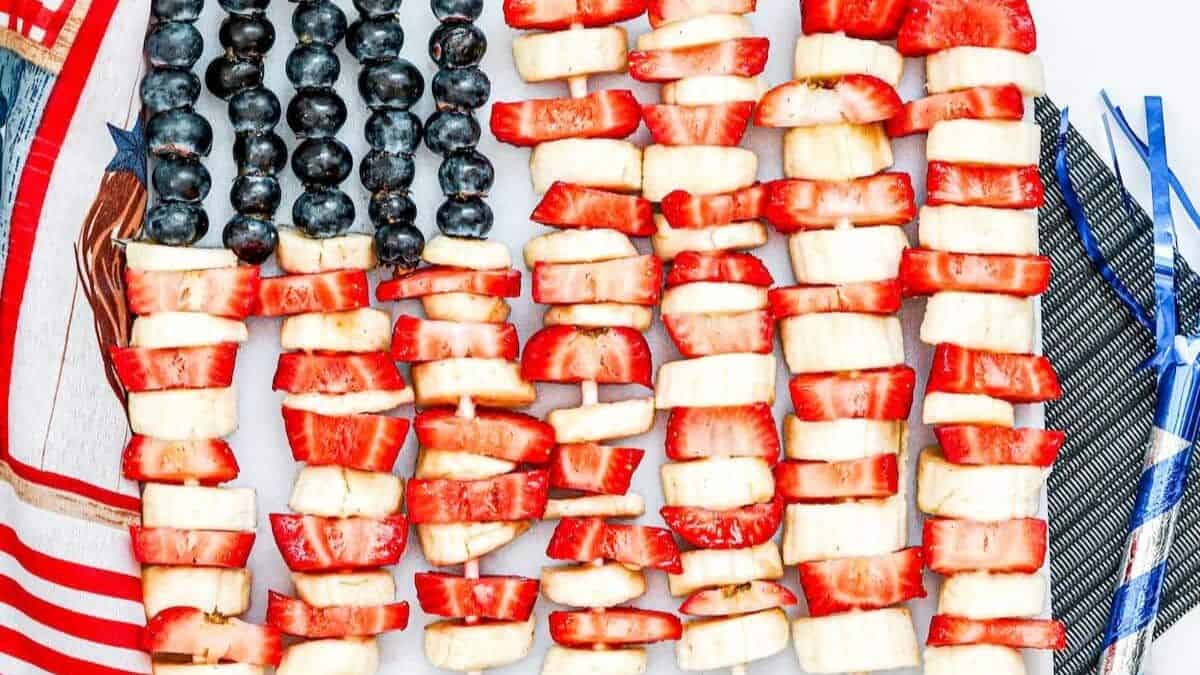 A platter of fruits that captures the color and design of the American Flag. Blueberries, bananas, and strawberries. 