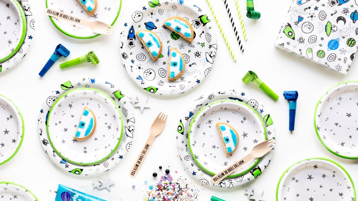 A couple of pieces of R2D Star Wars Cookies set on starry designed plates. 