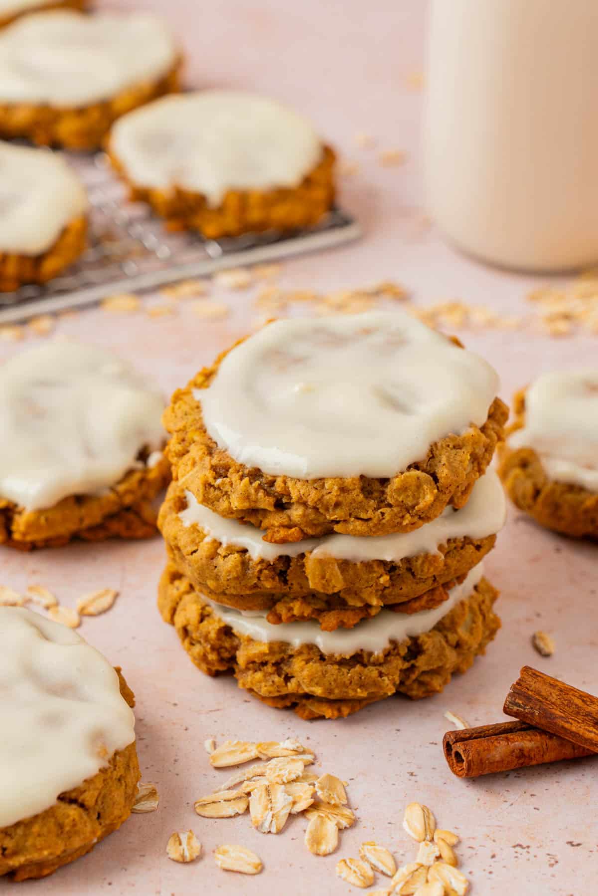 A stack of pumpkin oatmeal cookies with icing. 