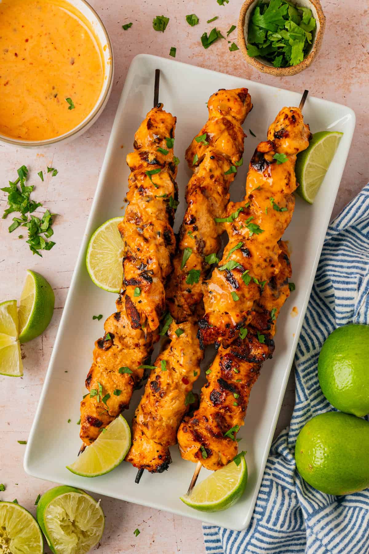 bang bang chicken skewers on a platter. 