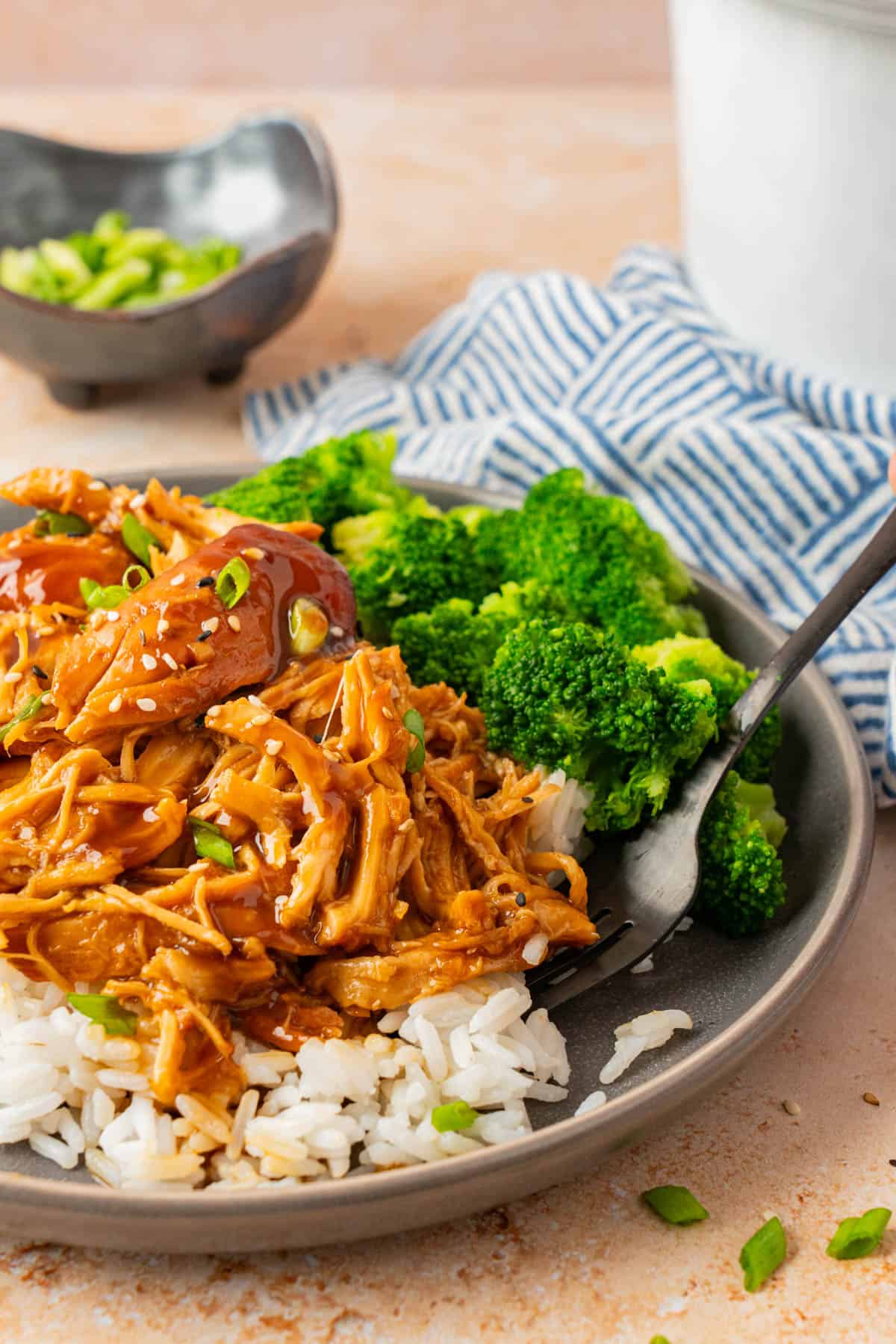 The chicken plated with rice and broccoli. 