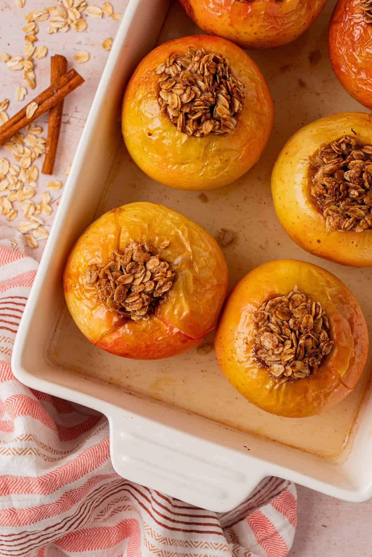 Baked cinnamon apples stuffed with oat filling in a baking dish