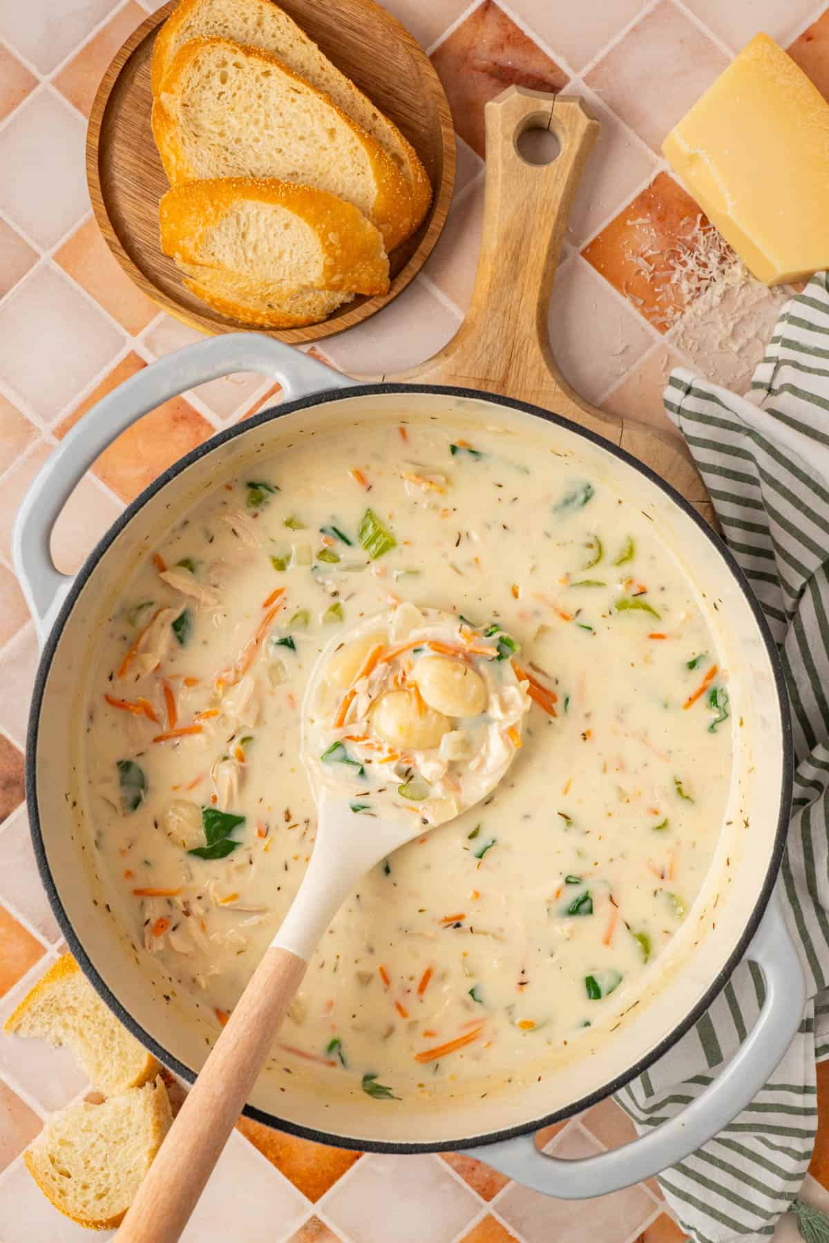 A pot of chicken gnocchi soup with vegetables. 
